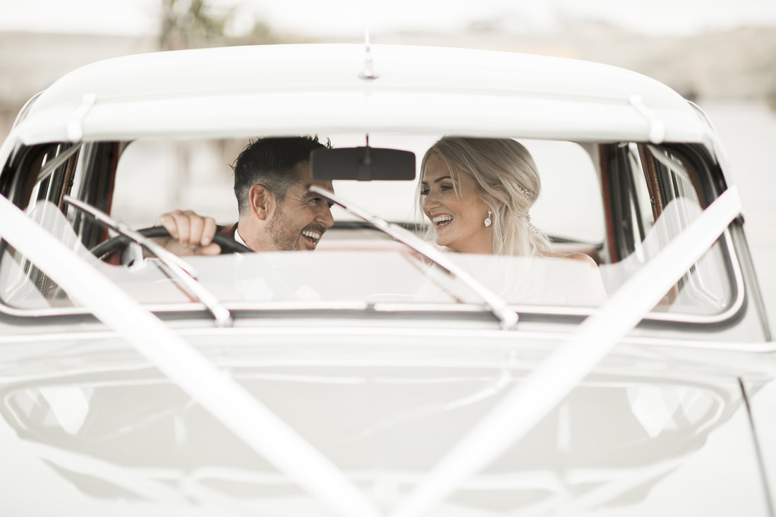 Bride and a groom in a car