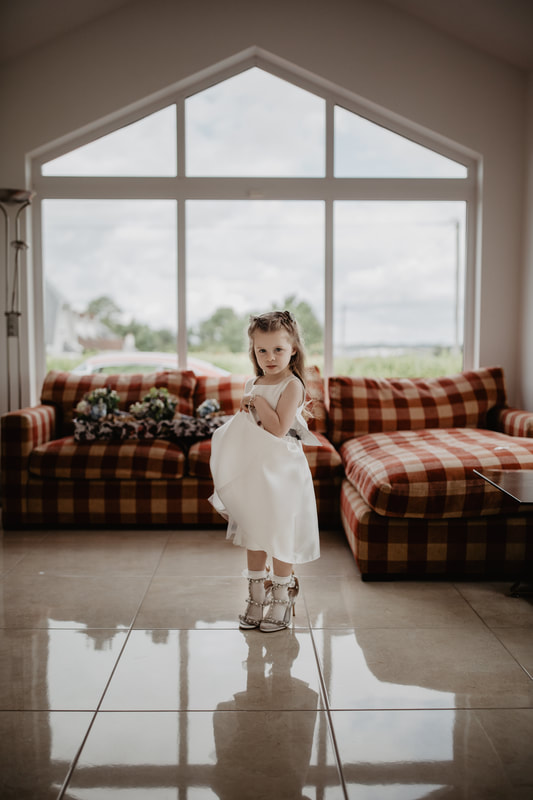 Little girl in a brides shoes 