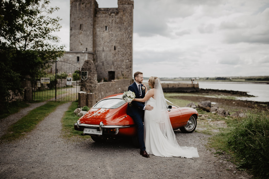 Red Jaguar E type  and bride and groom. Vintage wedding car. Photographer Mario