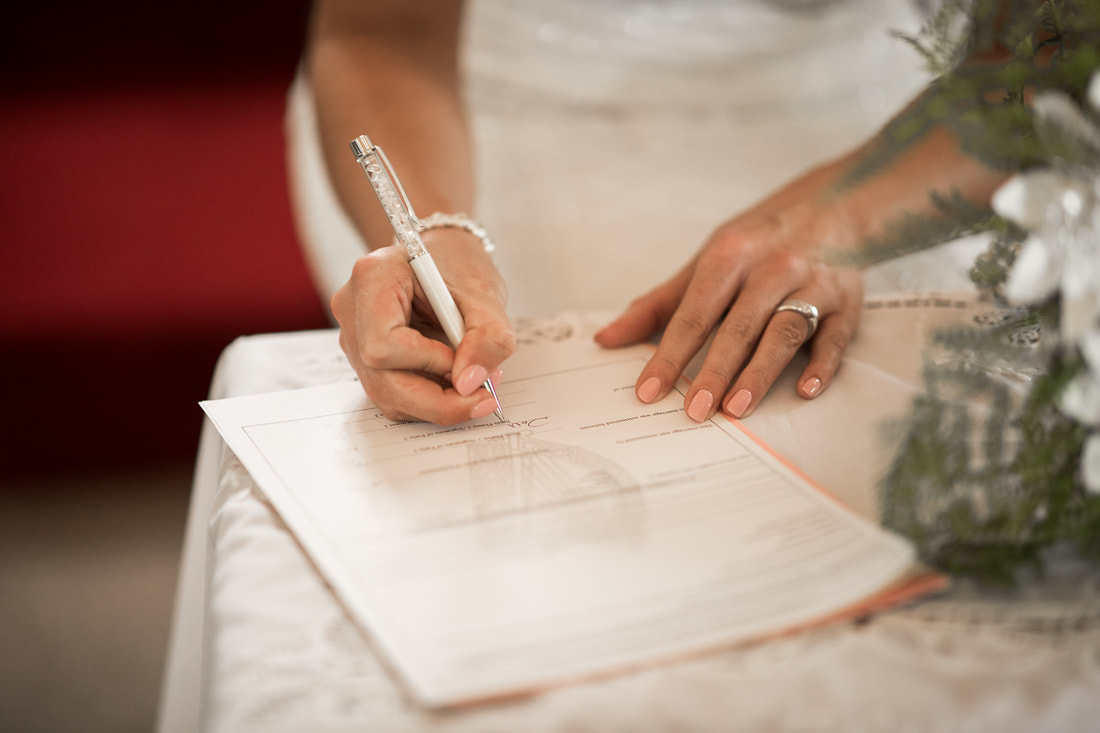 bride signs the documents at a wedding in Ireland