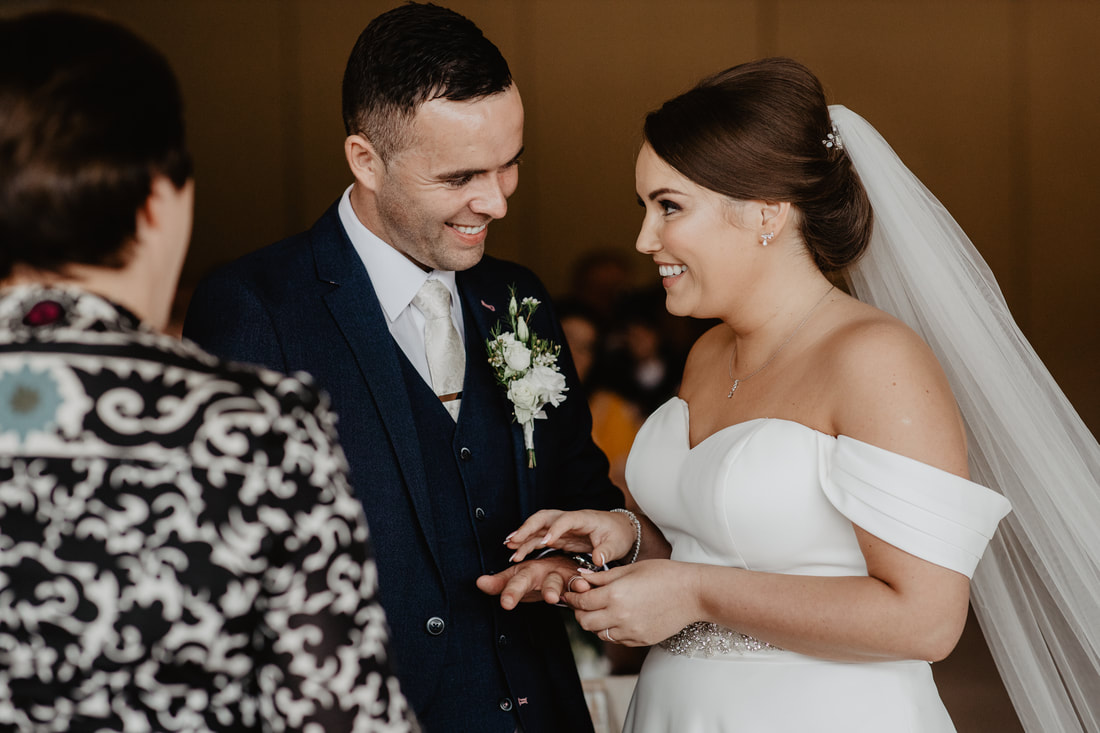 Bride puts the wedding ring on at Clanard Court Hotel, Athy, Co. Kildare by wedding photographer Mario Photo - Video Production