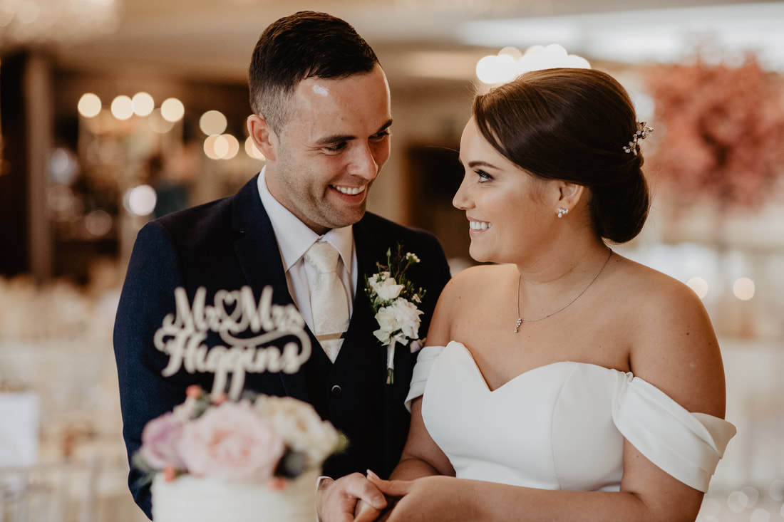 Bride and groom at a wedding cake. Wedding photographer in County Kildare Mario Vaitkus