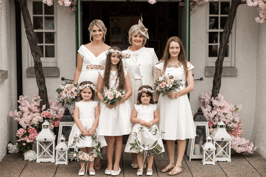 Stunning white dresses for bridesmaids, mom and flower girls. Photographer Mario
