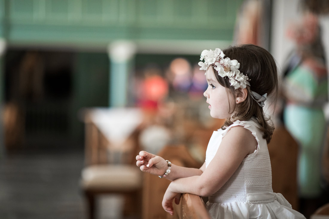 Flower girl dreaming at a wedding