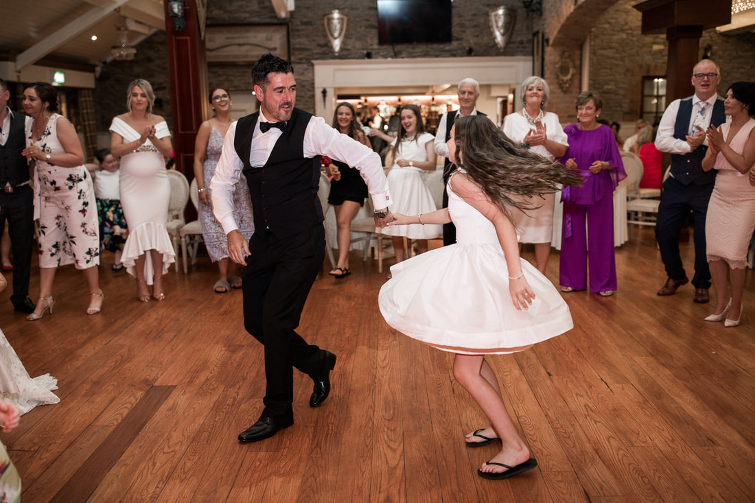 Groom dances with his daughter at a wedding