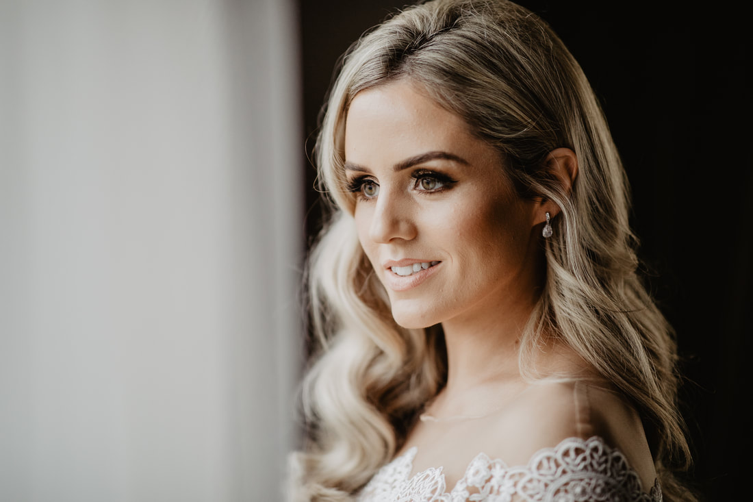 Bride at a window. Best wedding photography in Mallow