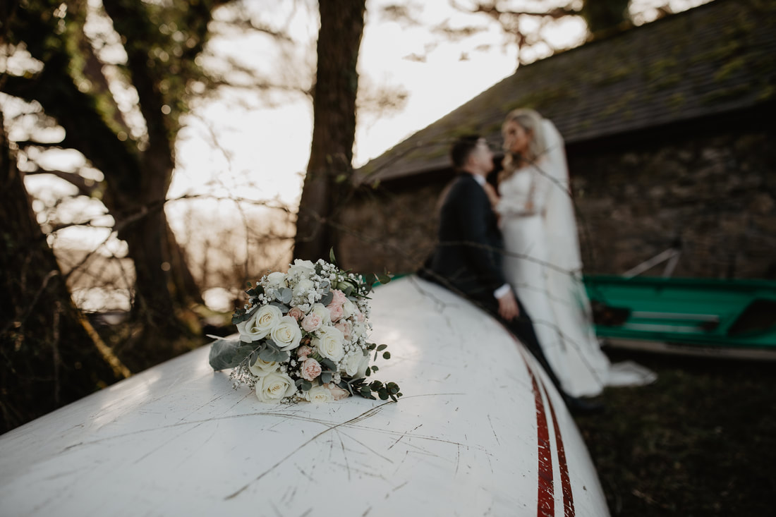 Wedding bouquet on a boat. Photographer Mario Vaitkus at Ross Castle, Killarney, Co.Kerry 