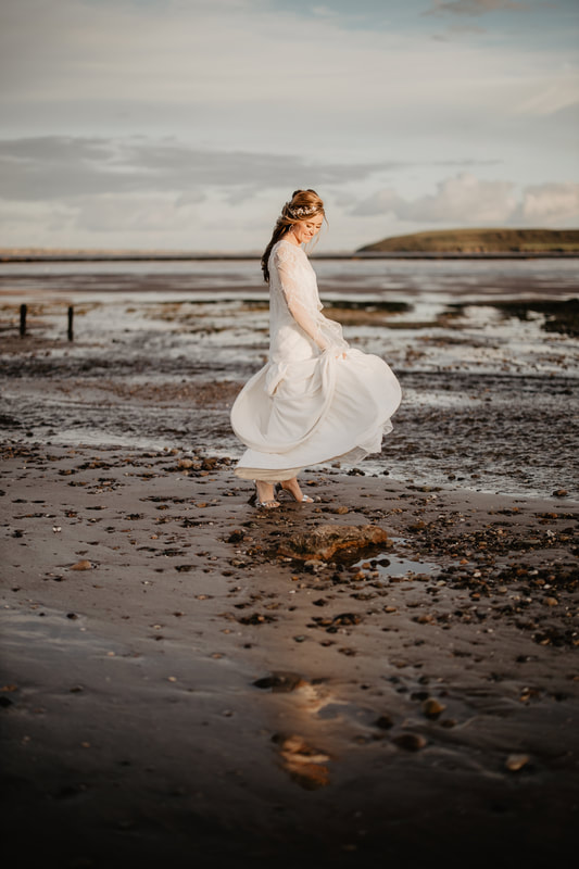 Bride on a beach in Wexford at a sunset. Photographer Mario Vaitkus