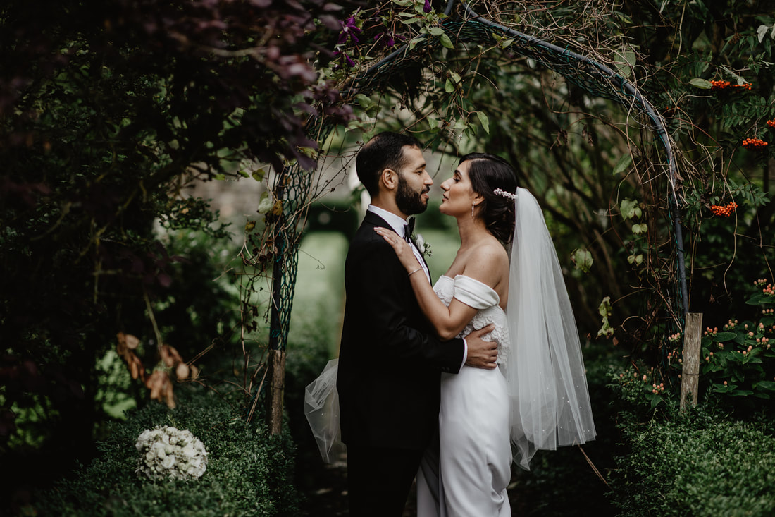 bride and groom going to kiss at their photoshoot at Knightsbrook hotel, secret gardens. Stunning photography by Mario Vaitkus