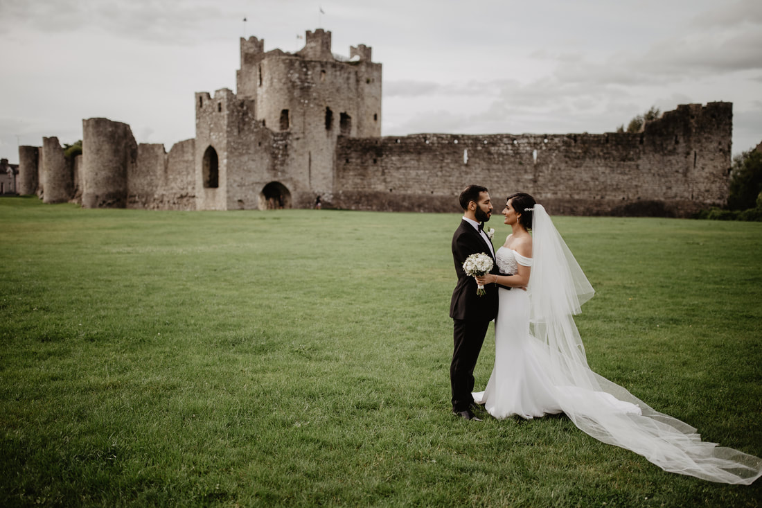 Bride and groom at Trim Castle. Stunning wedding photo by Mario Vaitkus