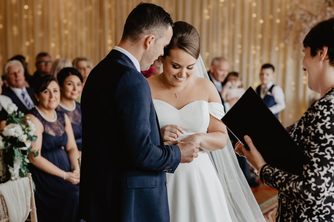 Groom puts the wedding ring on at Clanard Court Hotel, Athy, Co. Kildare by wedding photographer Mario Vaitkus