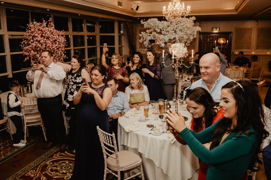 Guest with mobile phones at a wedding. Wedding photographer in County Kildare Mario Vaitkus